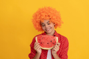 smiling teen girl in fancy orange hair wig hold fresh ripe watermelon fruit slice, joy