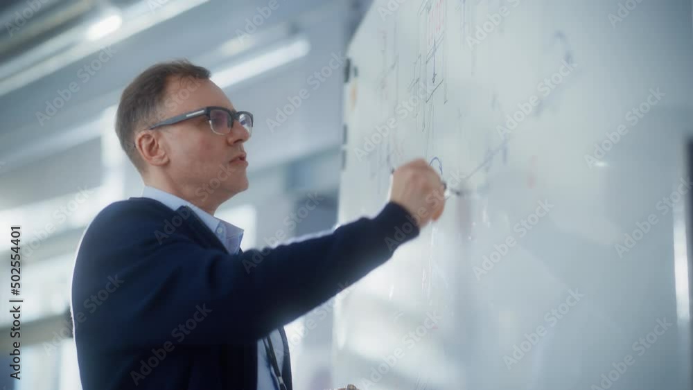 Poster male teacher write and draw car engine prototypes on the whiteboard while hold lecture or leads brie