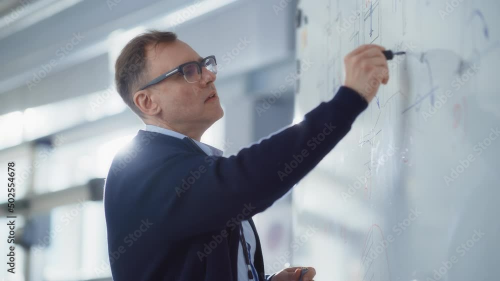 Poster male technician have a meeting, leads briefing, talks and draws formulas and numbers on digital inte