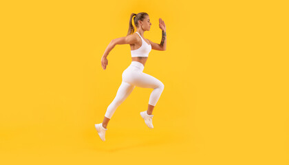 Fototapeta na wymiar active fitness woman runner running on yellow background