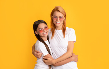 mother and daughter embrace in sunglasses. beauty and fashion. female fashion model.