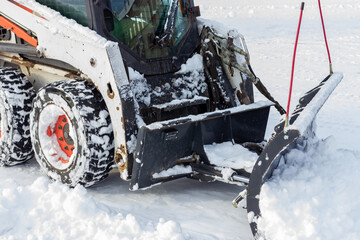 Snow removal with a bulldozer. Clearing the streets from snow. Blizzard.