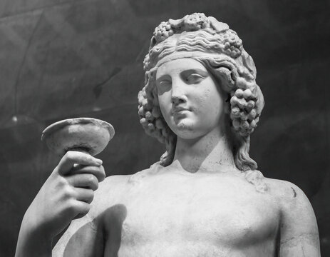 Ancient statue of Dionysus isolated on a white background. Dionysus is the God of the grape harvest, wine and merriment. Also known as Bacchus
