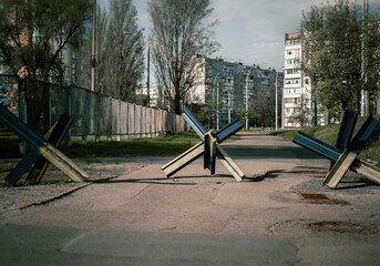 Anti-tank barriers or hedgehogs from the rails on the sidewalk of the city. Against war and violence. Ukrainian victory.