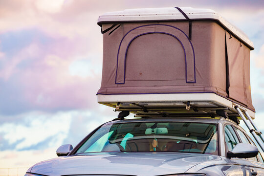 Car with roof top tent against sky