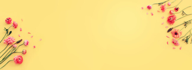Top view image of pink flowers composition over yellow background