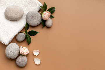 Spa treatment with stones and pink roses, top view