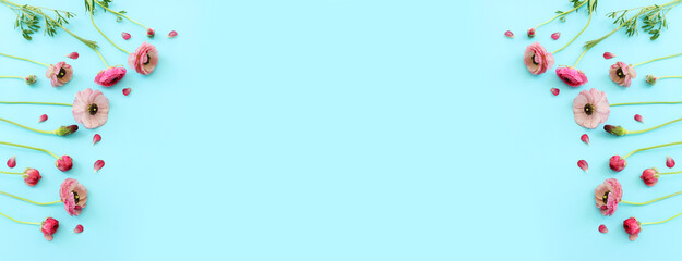 Top view image of pink flowers composition over blue background