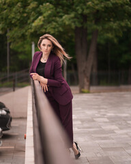 Fototapeta premium successful businesswoman in a business suit on the outside in full length