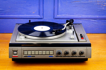 Vintage turntable vinyl record player with black vinyl