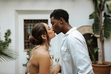 Affectionate young couple kissing in their backyard