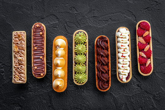 Sweet food pattern of eclairs with color topping. Sweet shacks