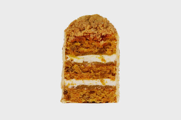 Front view image of sliced medovik cake with honey decorated with nuts isolated at white background.