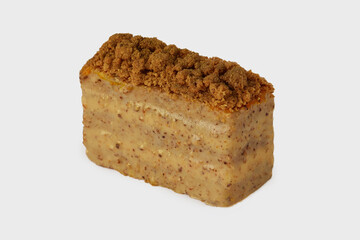 Closeup image of medovik cake with honey decorated with nuts isolated at white background.