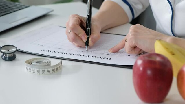 Nutritionist giving consultation to patient with healthy fruit and vegetable, wright nutrition weekly plan, diet concept