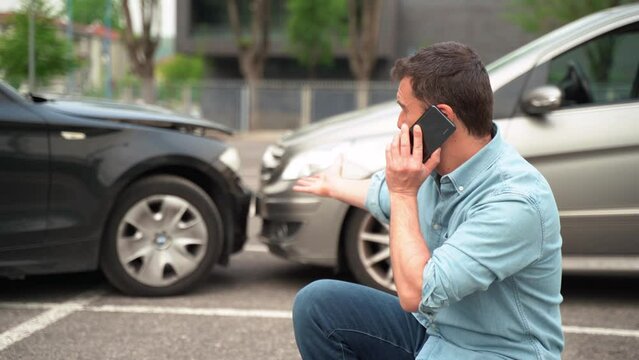 Video about one man calling roadside service assistance after car accident