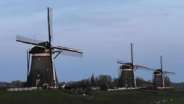 Three Dutch mills in 'polder' landscape Leidschendam, the Netherlands