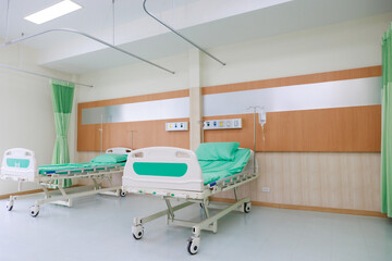 Two beds in common patient room.  Recovery Room with beds and comfortable medical. Interior of an empty hospital room. Clean and empty room with a bed in the new medical center