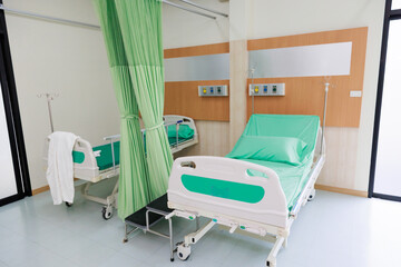 Two beds in common patient room.  Recovery Room with beds and comfortable medical. Interior of an empty hospital room. Clean and empty room with a bed in the new medical center