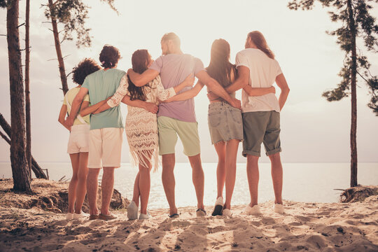 Photo of cute sweet young six friends wear casual clothes hugging watching sunset outside countryside