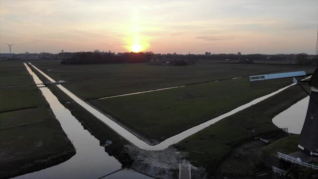 Three Dutch mills in 'polder' landscape Leidschendam, the Netherlands filmed with drone