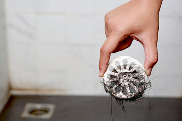 clogged pipe, anti-odor strainer with foul-smelling garbage in the bathroom