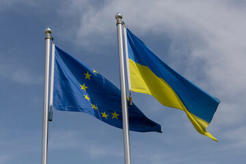 European Union and Ukrainian flags on flagpoles