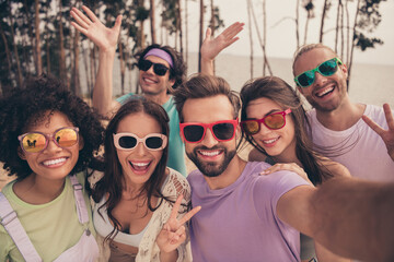 Photo of funky pretty young six friends wear casual clothes dark eyewear tacking selfie showing...