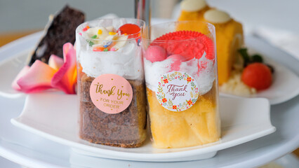 Selection of various sweets and cakes, cupcakes, pies, chocolate cake and chocolate brownie on white plate. Assortment of homemade pastry, bakery and desserts for tea or coffee break, lunch, brunch.