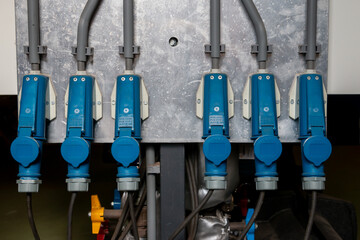 Blue plugs for three-phase power in an industrial environment for driving pumps and fans or heating