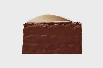 Front  view image of black forest cake piece with chocolate and cherry isolated at white background. Schwarzwald dessert.