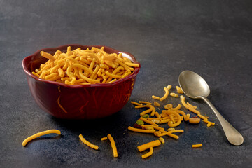 Traditional crunchy Indian savoury snack consisting of savoury noodles, split peas, peanuts, cashew nuts, green lentils and seasoning. Spicy snack. Copy space.