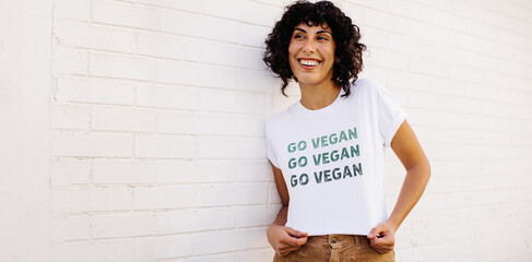 Vegan activist wearing a GO VEGAN shirt - obrazy, fototapety, plakaty