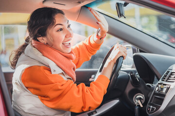 Polite woman driver raised her hand as a sign of respect and says thank you for giving way....