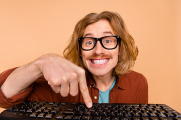 Portrait of handsome trendy cheery red-haired guy writing text learn remote isolated over beige...