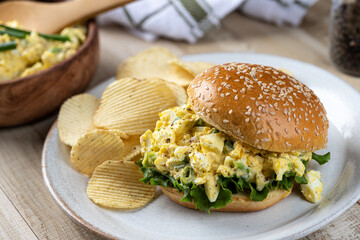 Egg salad sandwich with lettuce on sesame seed bun