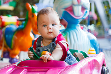 Fototapeta na wymiar handsome little boy on amusement ride machine