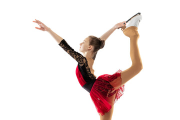 Portrait of little flexible girl, figure skating wearing stage attire posing isolated on white...