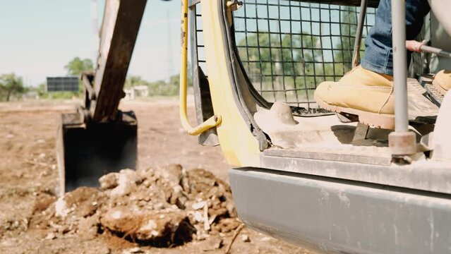 Big yellow backhoe excavator excavating