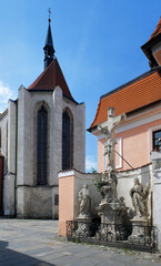 Sculpted crucifix and Church of Presentation of Virgin Mary in Ceske Budejovice, Czech Republic