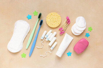 Flat lay of female personal hygiene items on beige background, top view