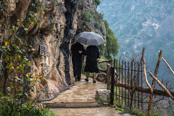 Nun and priest in Monastery of Our Lady of Qannoubine Monastery in Kadisha Valley, Lebanon