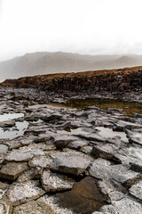 Black rock texture. Volcanic mountain surface close-up