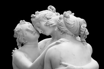 The Three Graces, Le tre Grazie. Neoclassical sculpture, in marble, of the mythological three charites isolated on black background with clipping path
