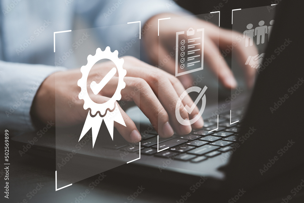 Poster Businessman using laptop computer with quality assurance and document icon for ISO or International Standard Organisation which related quality control and continuous improvement concept.