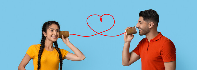 Middle eastern guy sending romantic message to girlfriend through paper cup phone