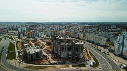 Fototapeta na wymiar Large construction site. Construction of modern multi-storey residential buildings. Construction of apartment buildings from concrete and glass. Aerial photography.