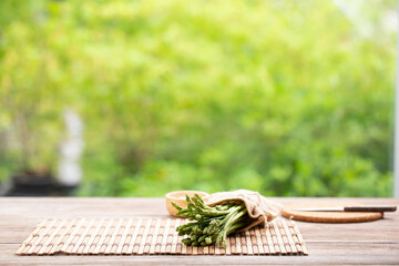 Asparagus is green and straight vegetable. Fresh, green asparagus is crispy for cook on wood table.