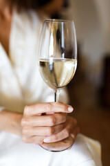 Bride in bathrobe holding wineglass