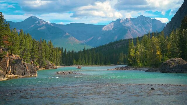 Bow River with raft and tourists near the village of Banff in Alberta, Canada